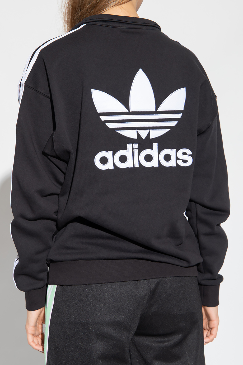 Adidas hoodie with store logo on back